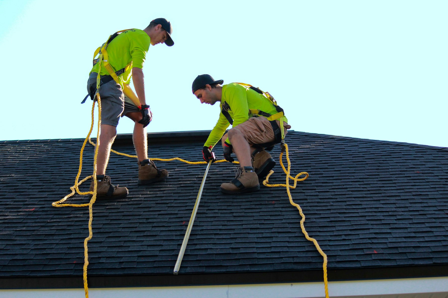 Roofing crew installing shingles on a residential roof